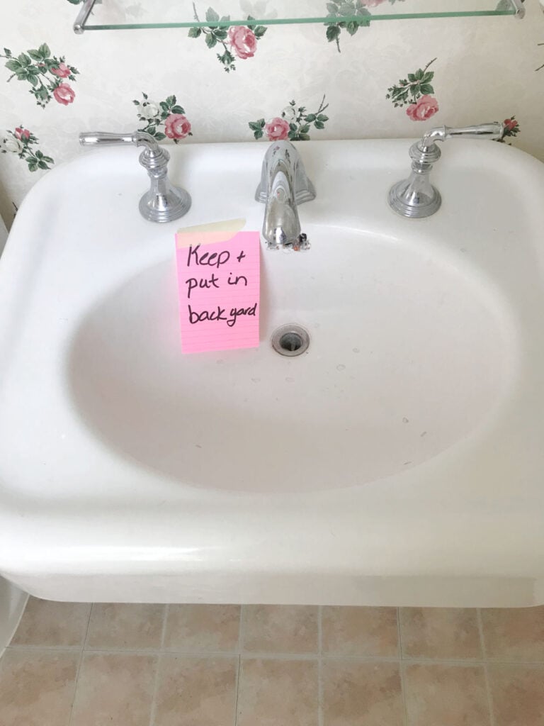 White old sink with a note to keep and place in backyard.