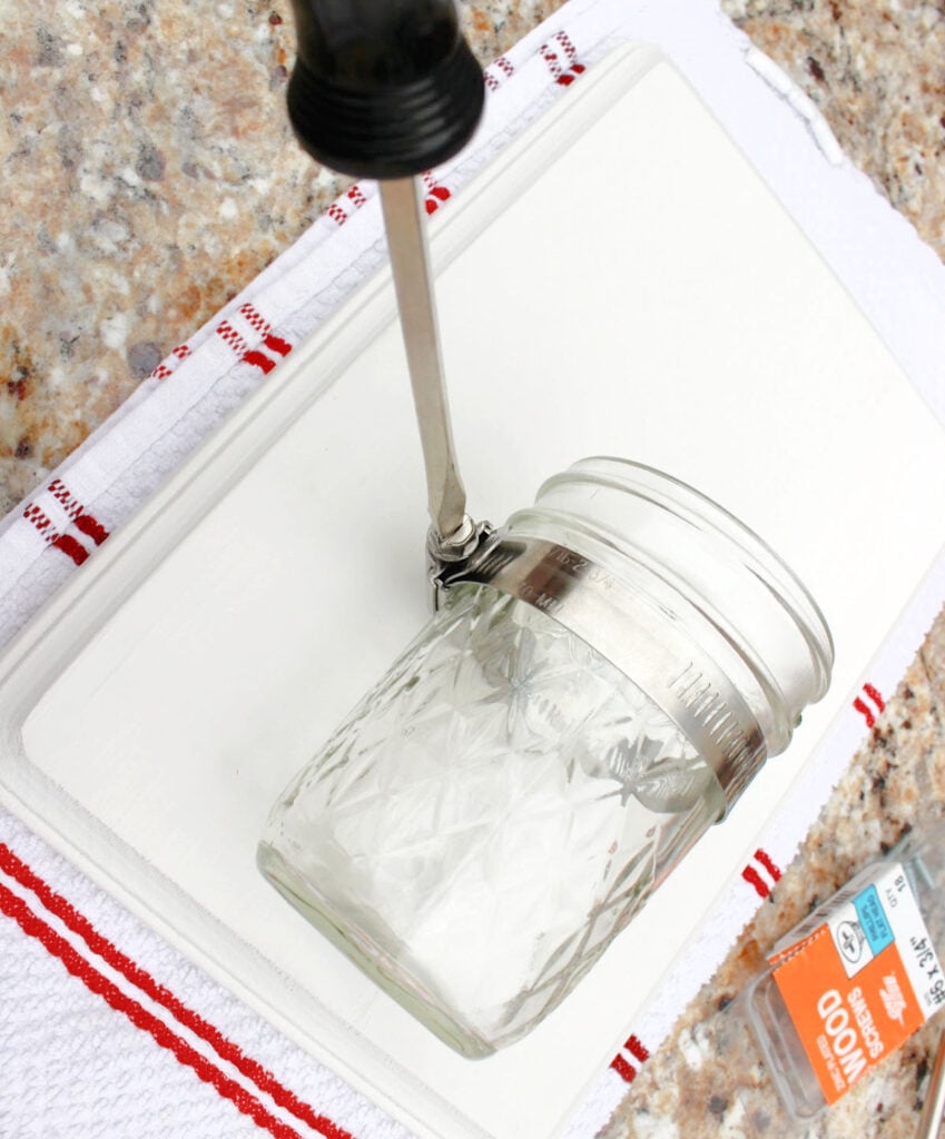 attach the mason jar in the clamp to the board.